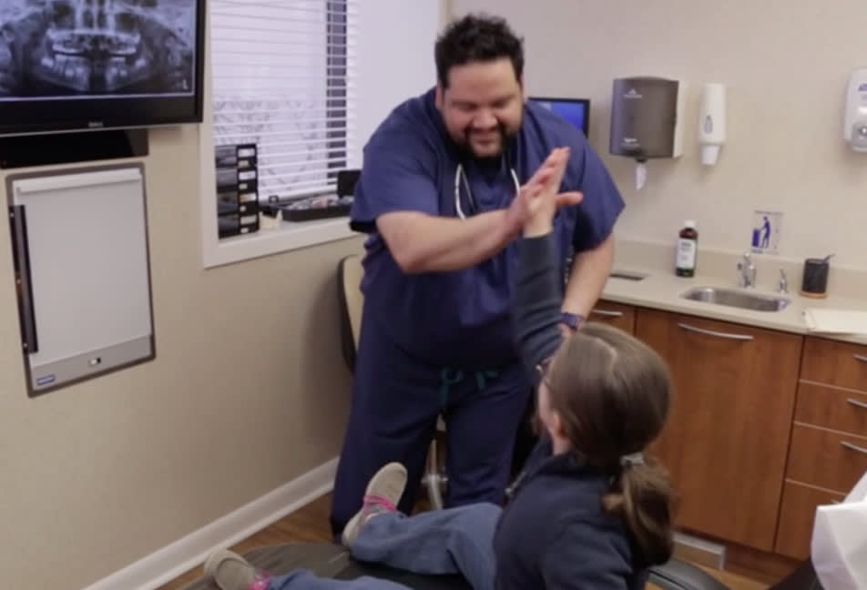 Dr. Lopez giving a young patient a high five