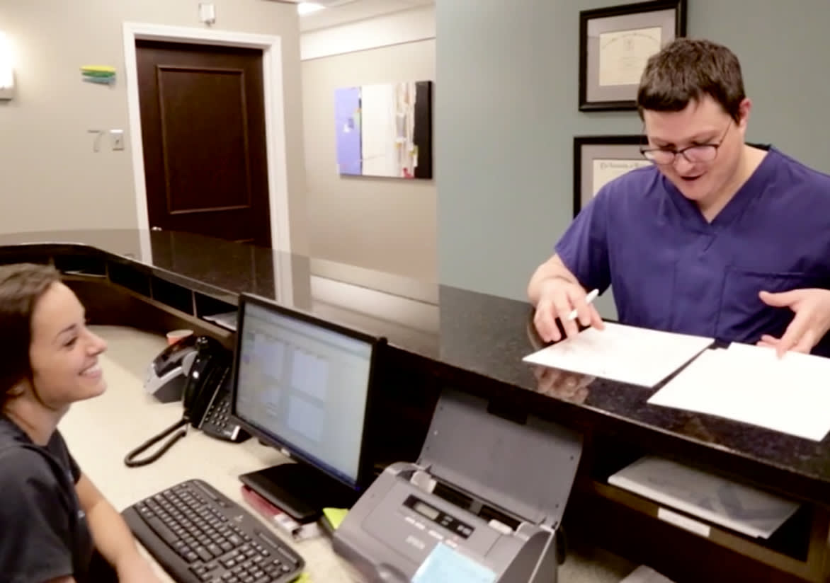 Dr. Sanker having conversation with the front desk staff